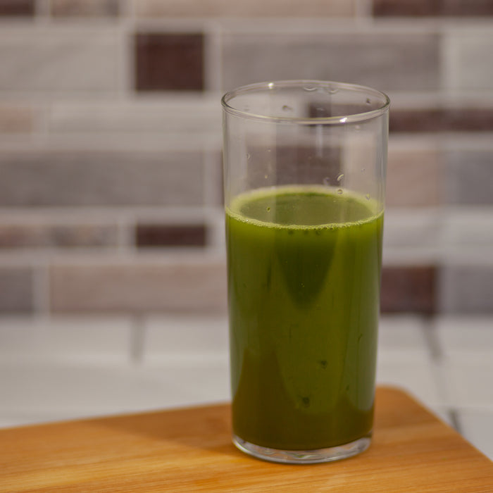 Organic Matcha mixed with water in a glass